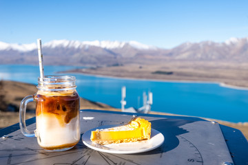 A cup of ice coffee  over the lake in New Zealand.