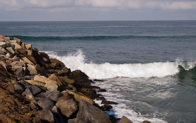 Waves breaking upon a rocky coast of the Pacific ocean in southern California, USA