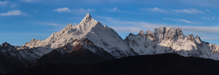 Meilixueshan - Meili Snow Mountain range in Deqen, Yunnan Province China. Panoramic daytime view of...