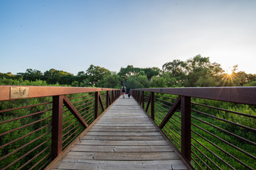 Girl walking her dog acrossed a bridge