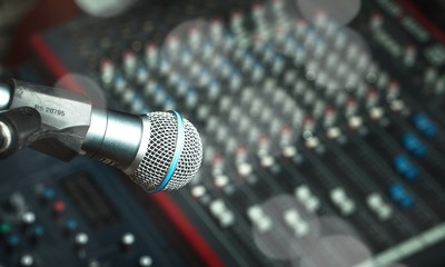 Microphone and  digital studio mixer  on background