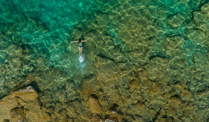 girl floating in the water, top view