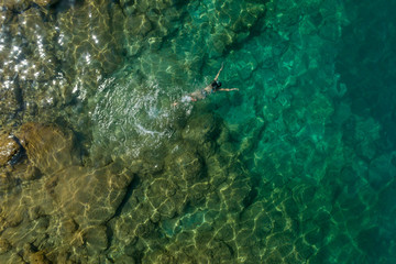 girl floating in the water, top view