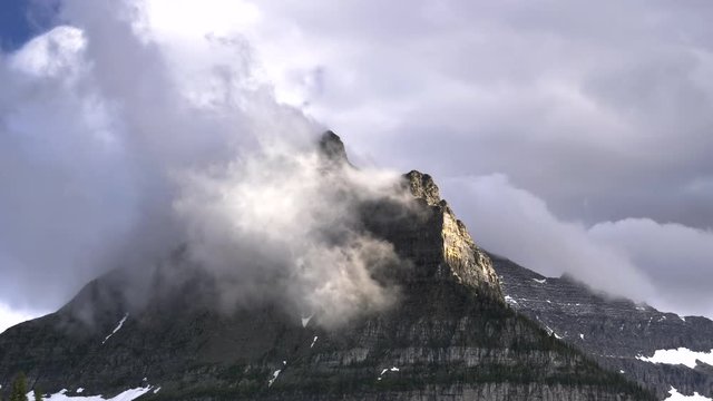 close up of storm clouds lifting from mount oberlin in glacier national park in montana, usa