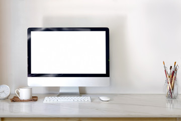 Desktop computer on marble desk with coffee and copy space.