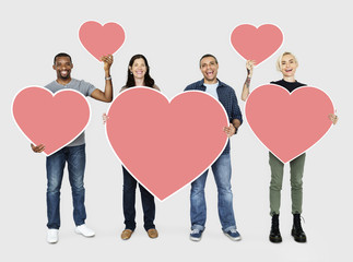 Happy diverse people holding hearts