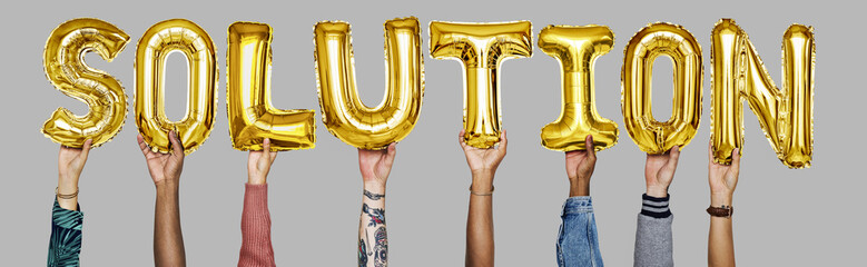 Gold yellow alphabet helium balloons forming the text solution