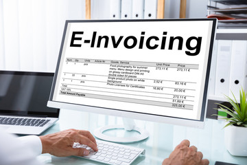 Businessman Preparing E-invoicing Bill On Computer