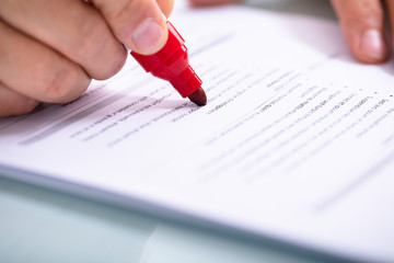 Businessperson Holding Marker On Document