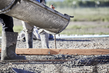 Cement truck chute pouring cement