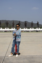 Thai woman travel and posing with Bronze statues of seven Thai kings at Rajabhakti Park