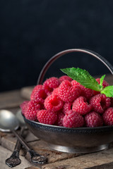 Rural still life with raspberries on rustic  table