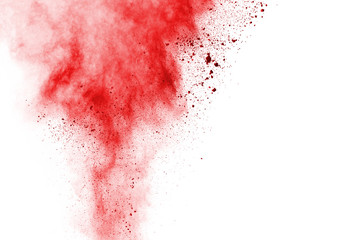 Freeze motion of red powder exploding, isolated on white background. Abstract design of red dust cloud. Particles explosion screen saver, wallpaper