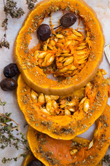 Backed and roasted sweet orange pumpkin round slices with oregano, garlic, olives and spices. Vegan lunch, vegetarian dinner, healthy food, vegetables. Delicious organic diet
