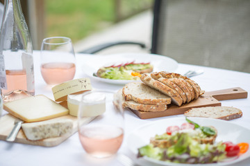 Cheese plate, bread and pink wine