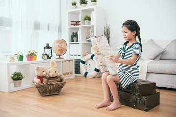 kid looking at the map in the living room