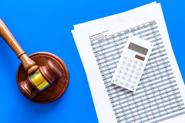 Bankruptcy concept. Judge gavel, documents, calculator on blue background top view