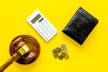 Bankruptcy concept. Judge gavel, wallet, coins, calculator on yellow background top view copy space