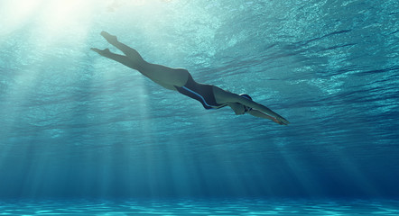 Woman swimming underwater in a sea.