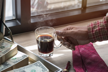 Fresh homemade black coffee and dollar in breakfast.Copy space.