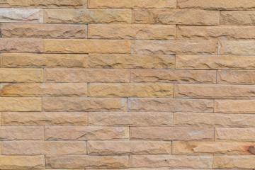 yellow stone wall  made with stone blocks