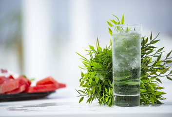 Close up glass of cold water with ice on a blurred background