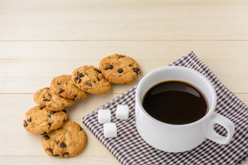 Cup of coffee with cookie on wood table time with copy space.