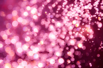 Pink bokeh of water drops levitating in the air reflection
