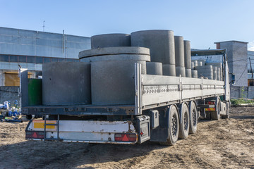 Delivery of building materials for construction site. Concrete rings and elements for a well.