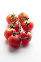 Bunch of fresh cherry tomato on white background