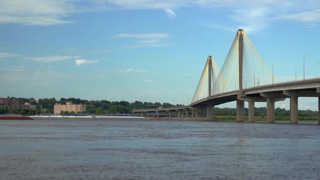 A long tow on the Mississippi River is approaching the  Clark bridge at Alton, 8x fast speed.
