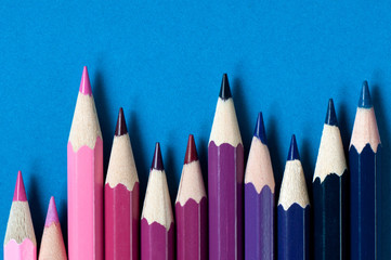 Color pencils isolated on blue background.

