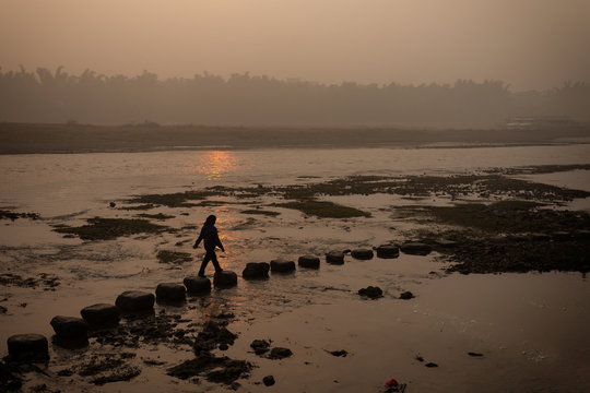 Walking on stepping stone foggy morning down by the river