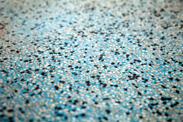 Stone crumb concrete floor at a bathroom. Blue and gray abstract blurry background