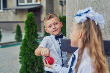 Primary school pupil. Children with backpacks near the school building at recess . Beginning of the...