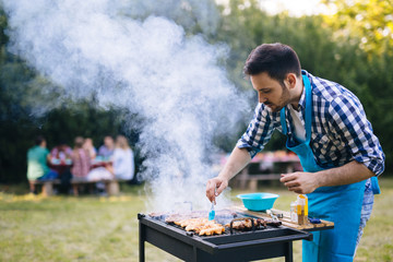 Handsome man preparing barbecue