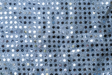 Texture of silver sequins. Close-up macro abstract background. Fabric with spangles