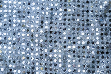 Texture of silver sequins. Close-up macro abstract background. Fabric with spangles