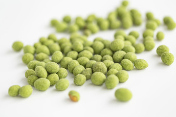 Peanuts coated with wasabi isolated on a white background