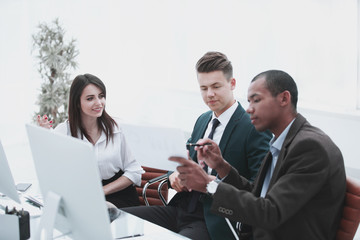 business team talking while sitting at a Desk