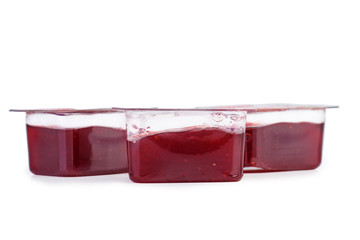 Small plastic containers with strawberry jam