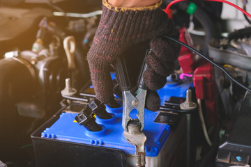 Battery charging cables transferring power , Man calling to car Mechanic service