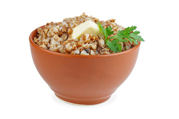 Bowl of boiled buckwheat grains with green branch of parsley