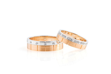 Rose gold and white gold wedding rings isolated on white background