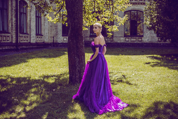 Obraz na płótnie Canvas Young Ballerina in vintage look. Ballet Dancer Girl. Image of a Dancing Woman. Lady in purple evening dress demonstrated femininity. Classical Choreography Style 
