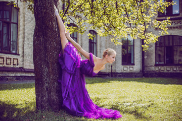 Young Ballerina in vintage look. Ballet Dancer Girl. Image of a Dancing Woman. Lady in purple evening dress demonstrated femininity. Classical Choreography Style 