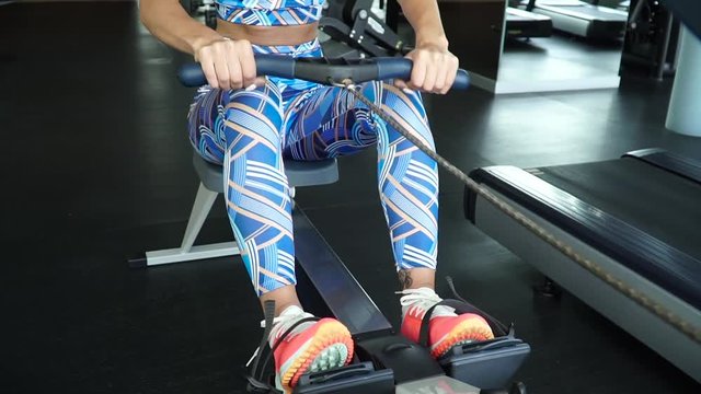 Beautiful girl trains in the gym.