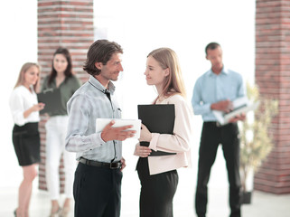 Fototapeta na wymiar business colleagues talking, standing in a modern office