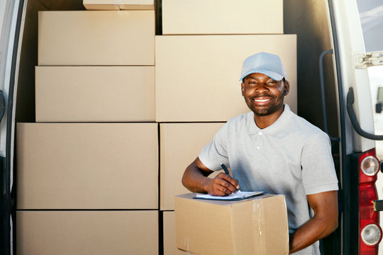 Courier Service. Delivery Man With Boxes Near Car