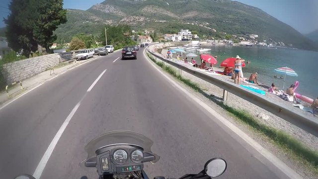 travel concept riding on bike by montenegro kotor bay.